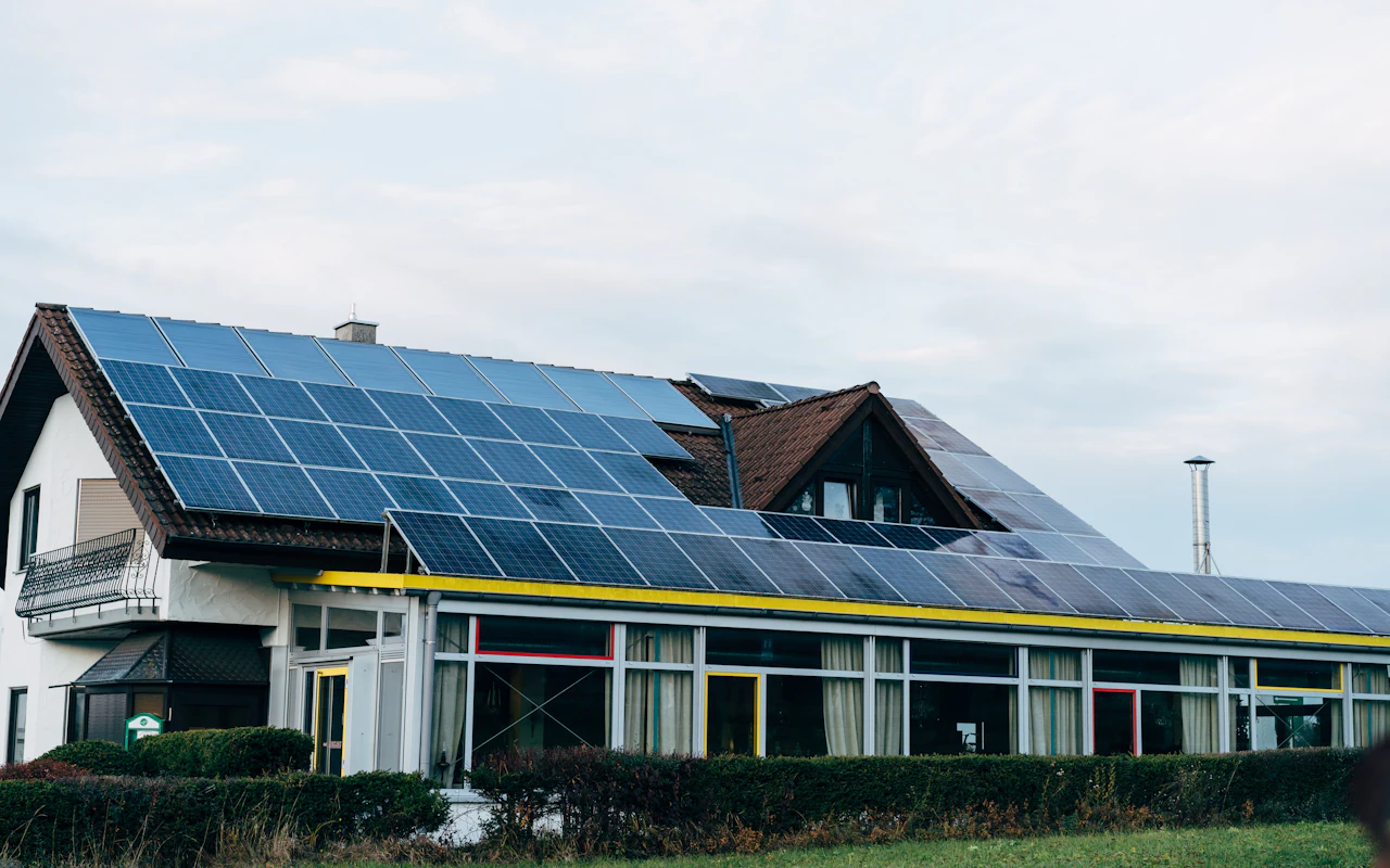 Home with rooftop solar panels under a clear sky